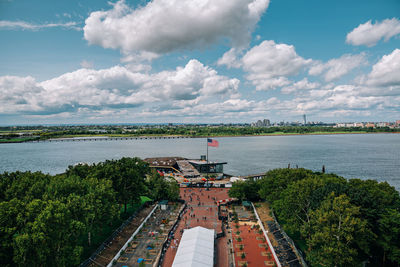 High angle view of buildings by sea against sky