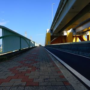 Empty road along buildings