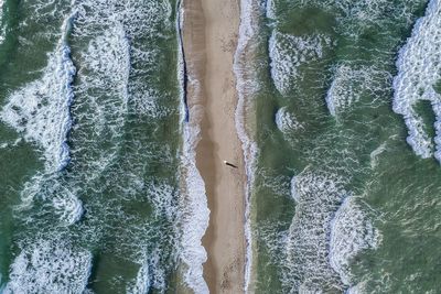 High angle view of surf on beach