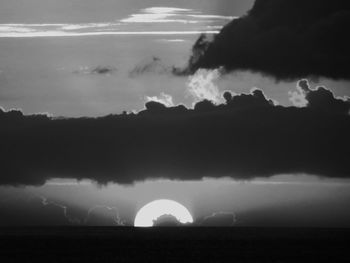 Silhouette landscape against sky at night