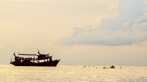 Boat sailing in sea against sky