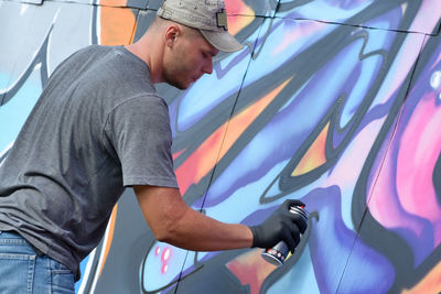 Side view of man working in car