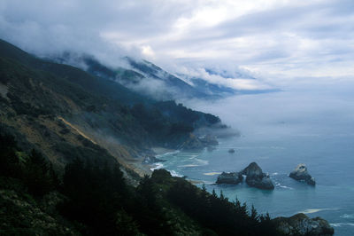 Scenic view of mountains against cloudy sky