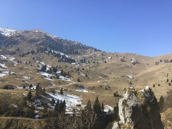 Scenic view of mountains against clear blue sky