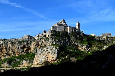 Low angle view of historic building against blue sky