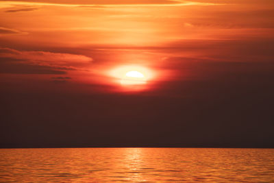 Scenic view of sea against orange sky