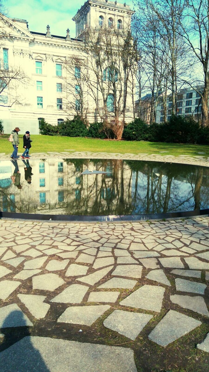 reflection, day, built structure, outdoors, building exterior, real people, water, tree, architecture, men, nature, sky, adults only, people, adult