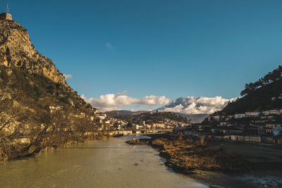 Scenic view of sea and mountains against sky