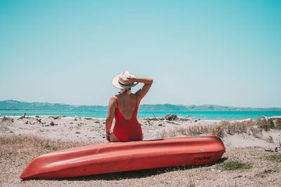 Man on beach against clear sky