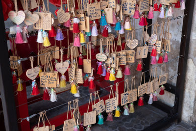 Multi colored umbrellas hanging in row at temple