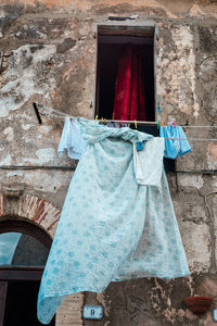 Low angle view of clothes drying against building