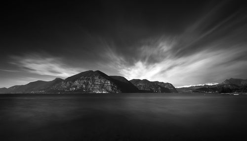 Scenic view of sea and mountains against sky