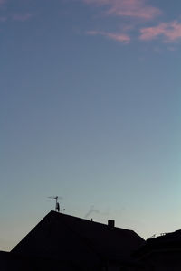 Silhouette building against clear sky at sunset