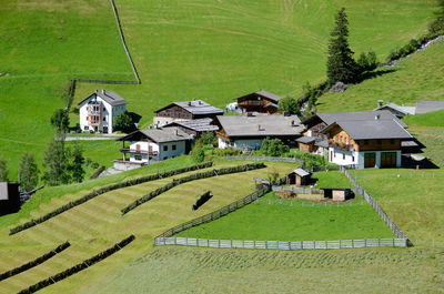 Scenic view of agricultural field by houses and buildings