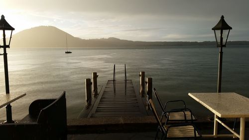 Pier on sea at sunset