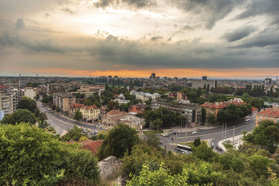 High angle view of buildings against cloudy sky