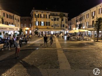 People on street in city at night