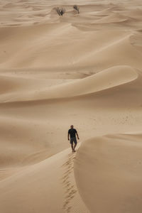 High angle view of man walking at desert