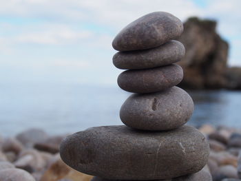 Close-up of stone stack on rock in sea