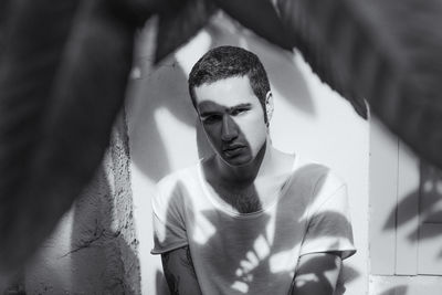 Close-up portrait of young man in sunlight