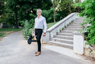 Portrait of man walking on staircase