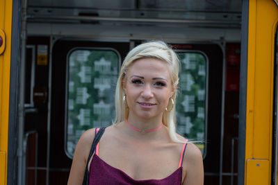 Young woman standing at railroad station