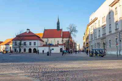 Buildings in city against clear sky