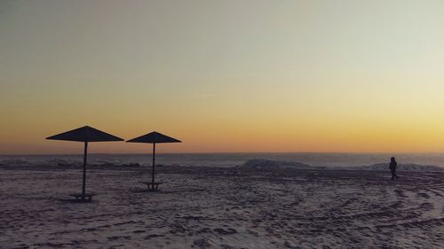 Scenic view of beach against sky during sunset