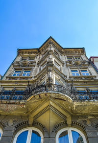 Low angle view of historical building against clear blue sky