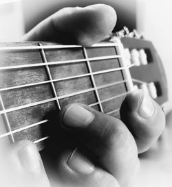 Close-up of hand holding guitar