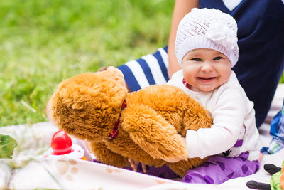 Portrait of cute baby girl with toy