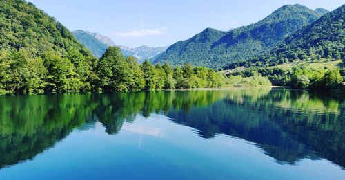 Scenic view of lake and mountains against sky