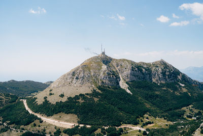Panoramic view of cross on mountain against sky