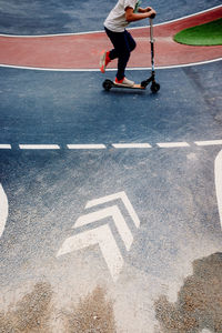 Low section of man with umbrella on road