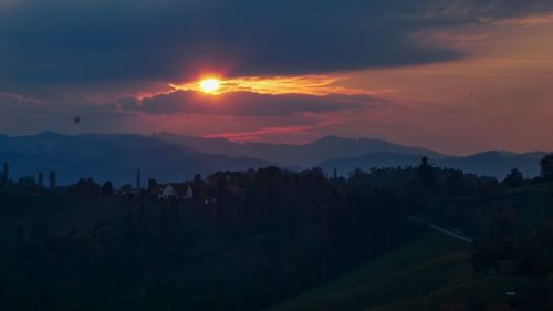 Scenic view of silhouette mountains against sky at sunset