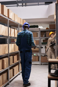 Full length of young man standing in factory