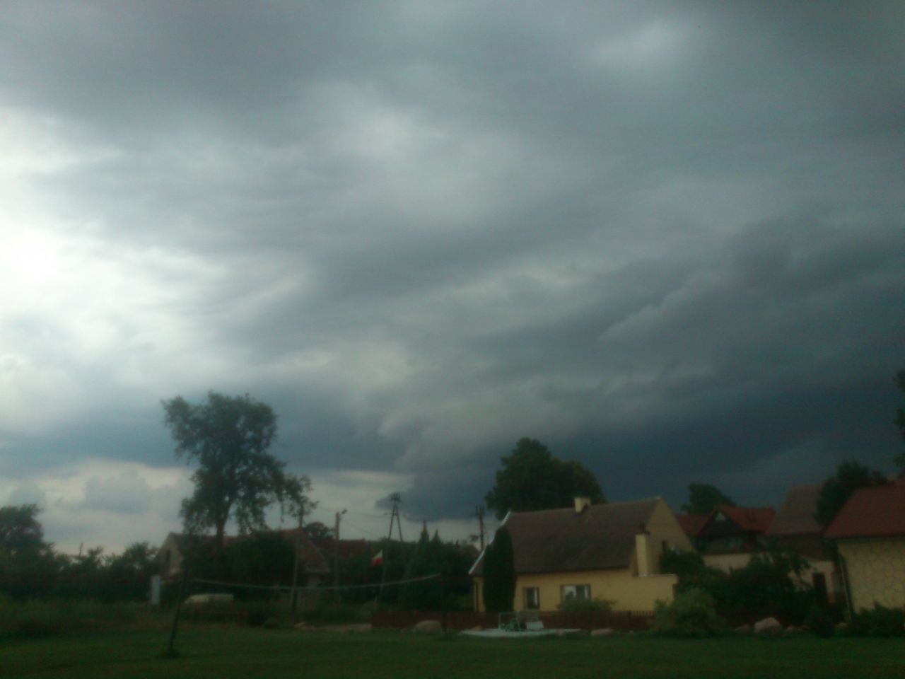 sky, cloud - sky, building exterior, cloudy, built structure, architecture, tree, house, grass, field, weather, overcast, landscape, cloud, storm cloud, nature, tranquility, tranquil scene, beauty in nature, dusk