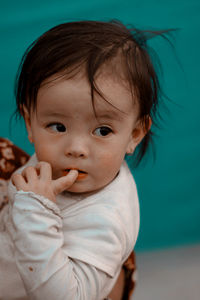 Close-up of cute baby looking away