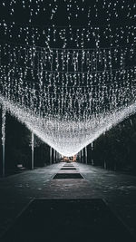 Illuminated lights on footpath at night