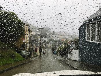 Raindrops on glass window of rainy season