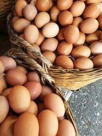 High angle view of brown eggs in baskets at market stall