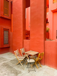 Empty chairs and tables in front of building