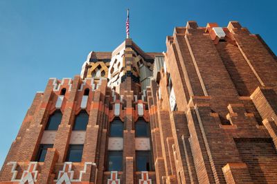 Low angle view of modern building against blue sky