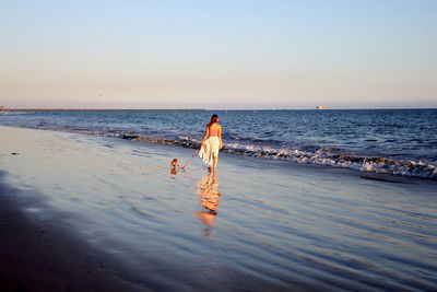 Full length of man on beach against sky