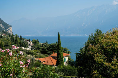 Scenic view of sea by buildings against sky