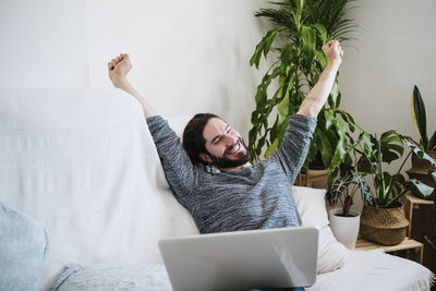 Young man using mobile phone at home