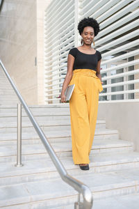 Happy woman moving down staircase