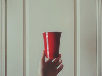 Close-up of hand holding red drink