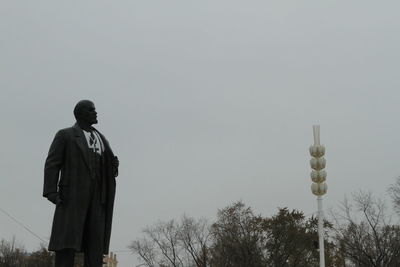 Rear view of man standing against sky