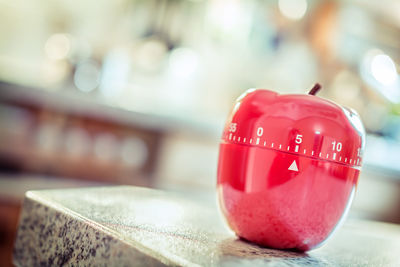 Close-up of apple shape dial on table